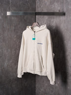 Off-white zip-up hoodie with hood, front zipper and Balenciaga logo detail