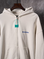 Off-white zip-up hoodie with hood, front pocket and Balenciaga logo patch