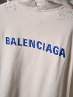 Off-white hoodie chest with large blue BALENCIAGA lettering