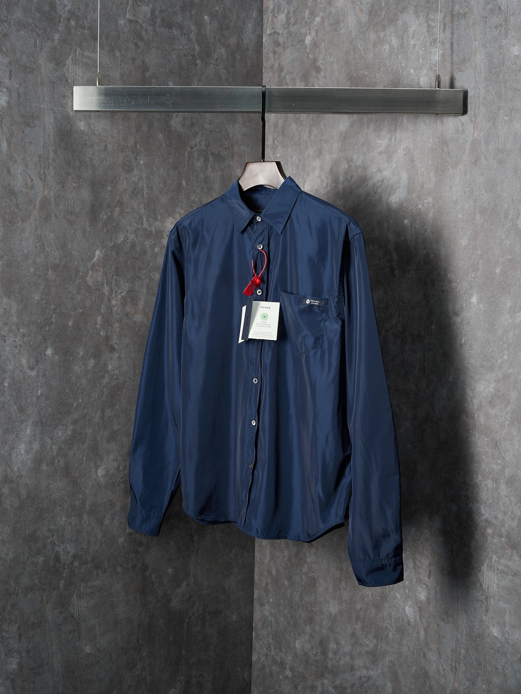 Navy Prada long-sleeve shirt with point collar and button front, product tags attached