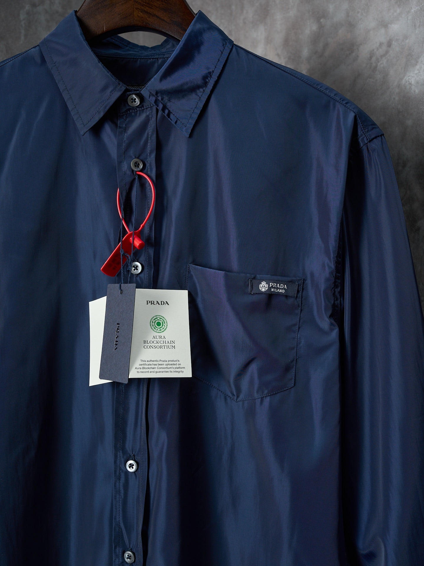 Navy Prada long-sleeve shirt with chest pocket and button front, hanging price tags