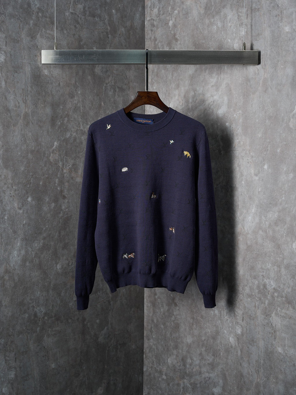 Long-sleeve knit sweater in dark navy with small multicolor animal logo embroidery
