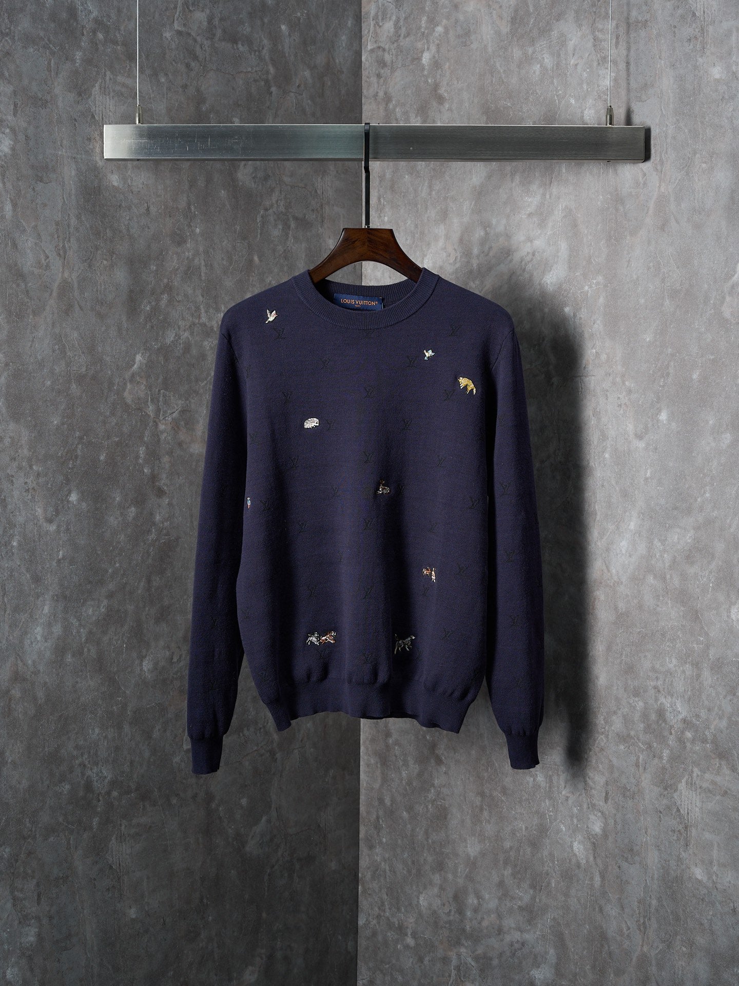 Long-sleeve knit sweater in dark navy with small multicolor animal logo embroidery