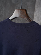 Dark navy knit sweater neckline with subtle allover logo pattern