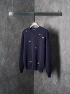Long-sleeve knit sweater in dark navy with scattered animal logo embroidery