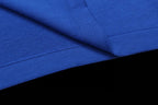 Blue T-shirt fabric close-up with folded seam and texture