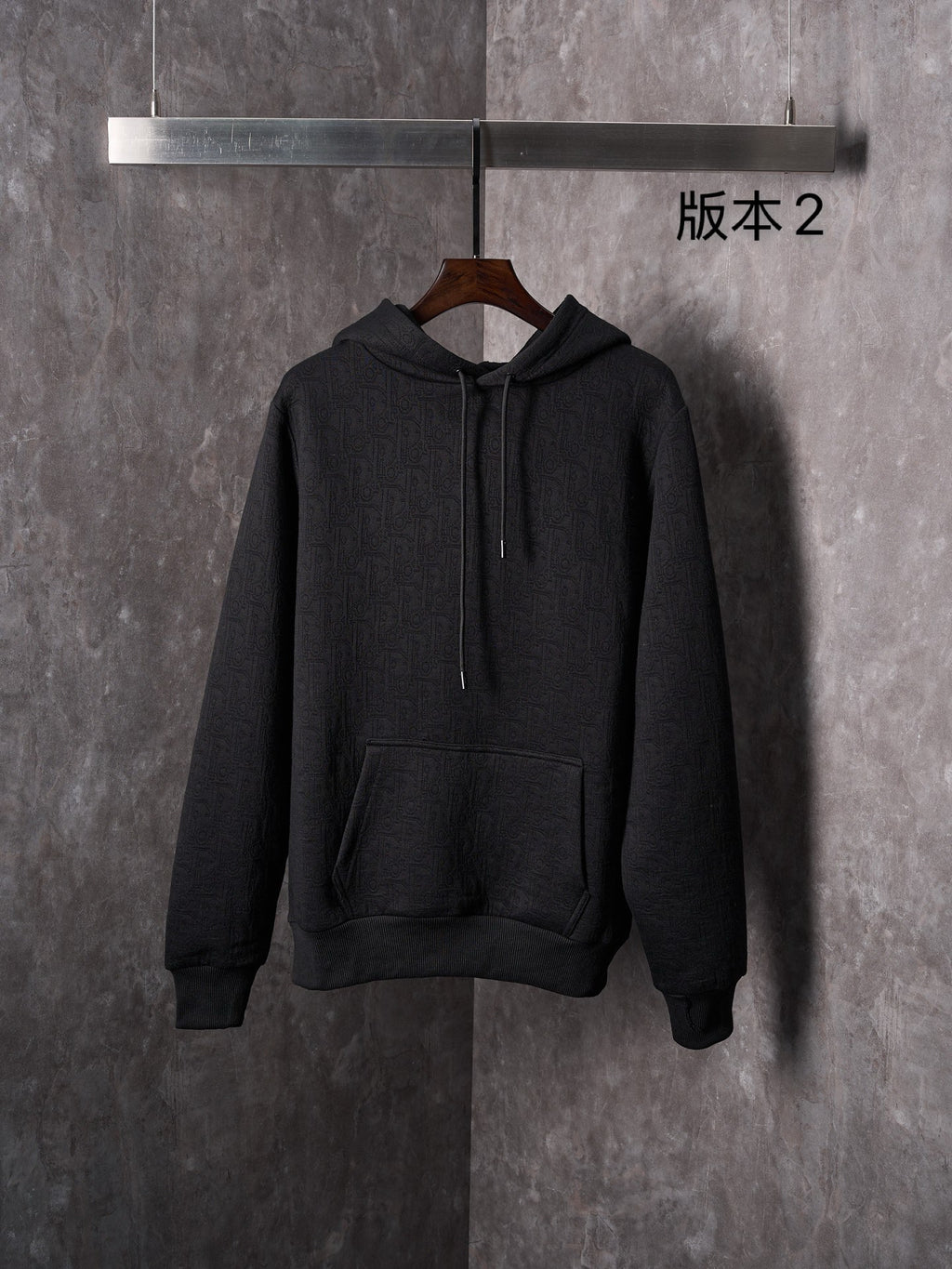 Black Dior long-sleeve hoodie with hood, drawstrings, and kangaroo pocket