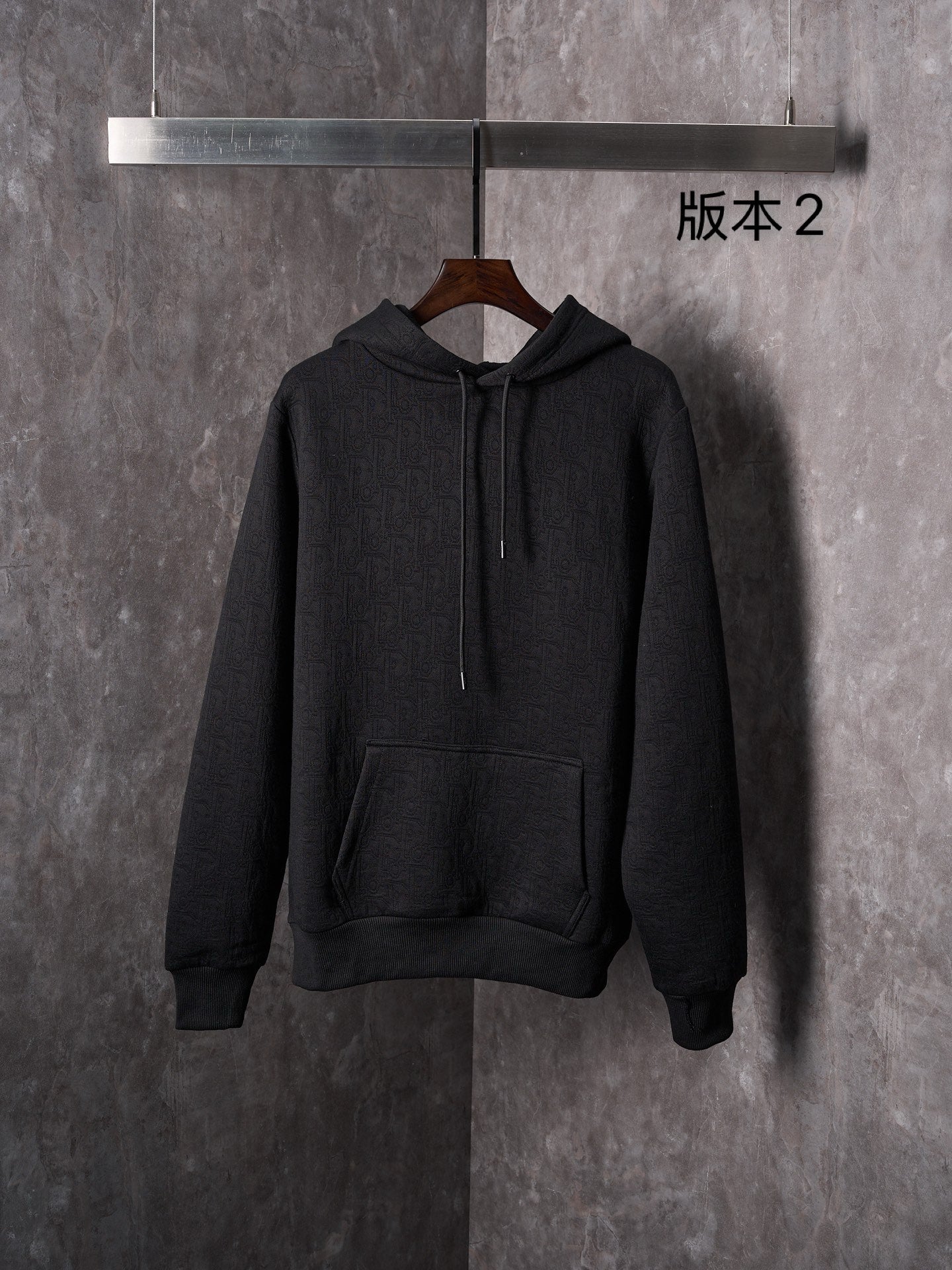 Black Dior long-sleeve hoodie with hood, drawstrings, and kangaroo pocket