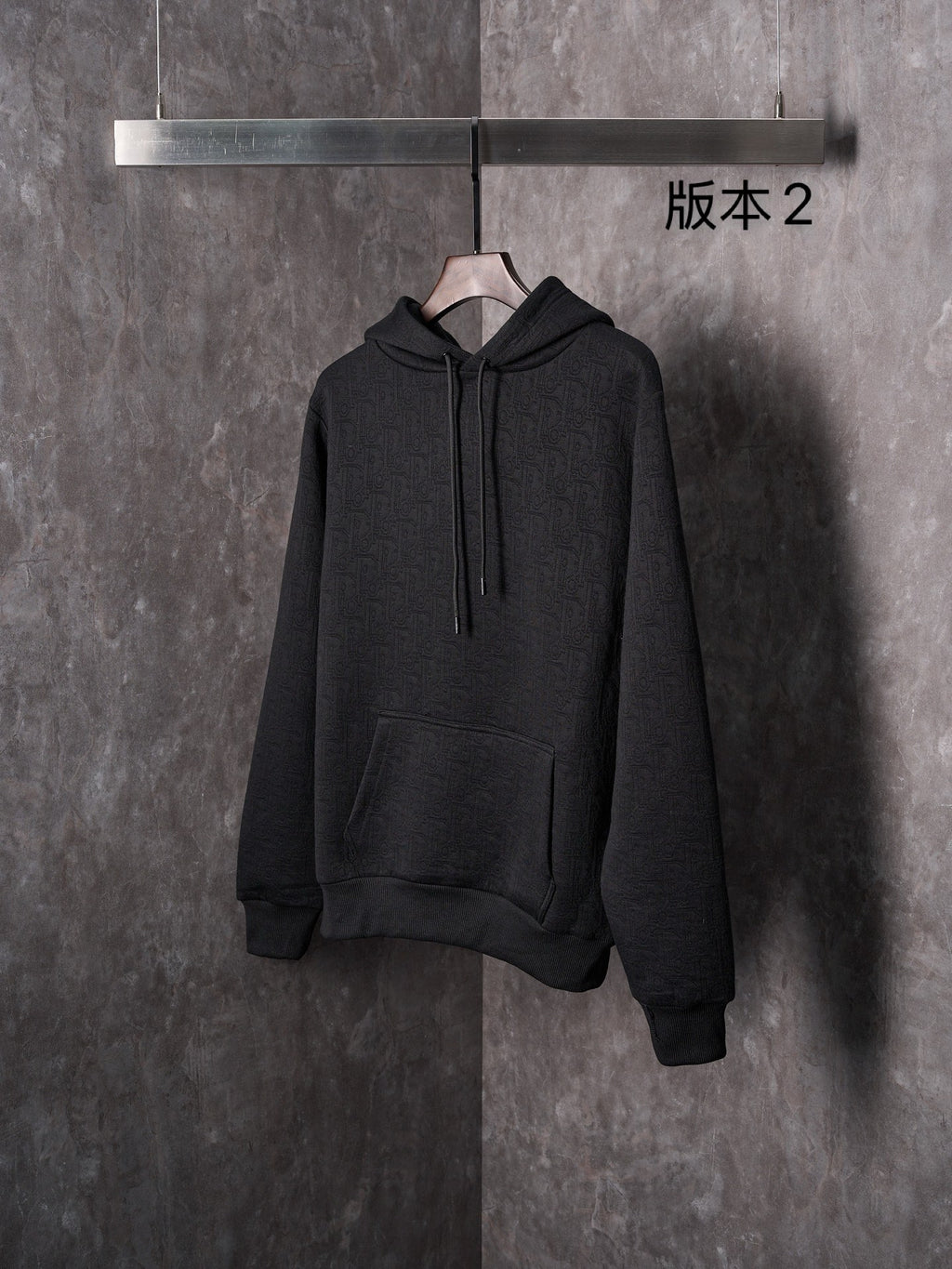Black Dior long-sleeve hoodie with hood, drawstrings, and front kangaroo pocket