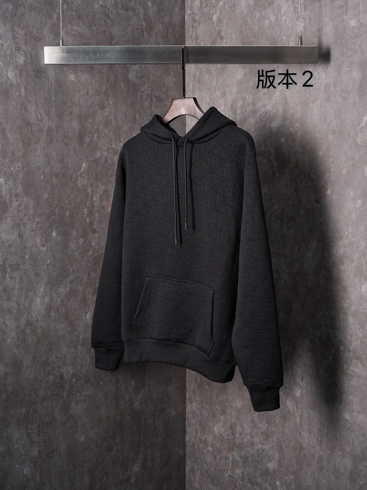 Black Dior long-sleeve hoodie with hood, drawstrings, and front kangaroo pocket