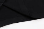 Black T-shirt fabric with visible seam and fold