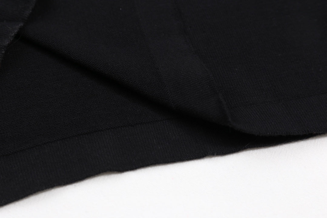 Black T-shirt fabric with visible seam and fold
