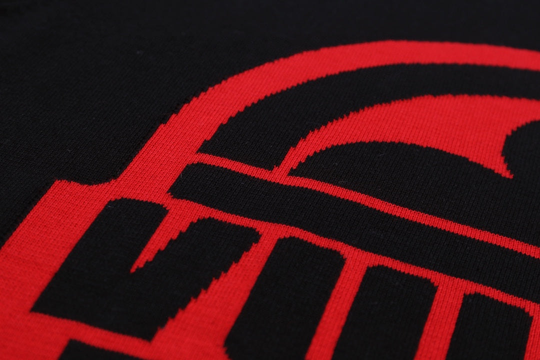 Black T-shirt with close-up of red logo lettering