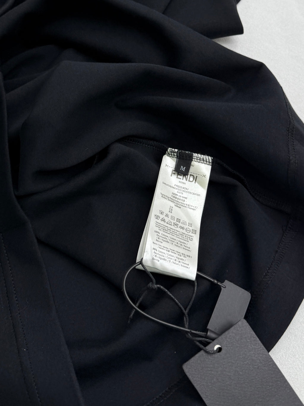 Fendi T-shirt with size and care tag attached in dark navy