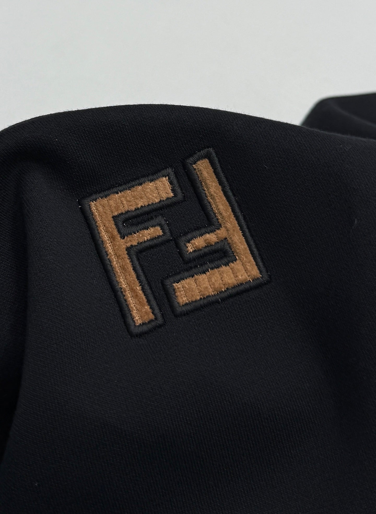 Fendi embroidered FF logo patch on dark navy T-shirt