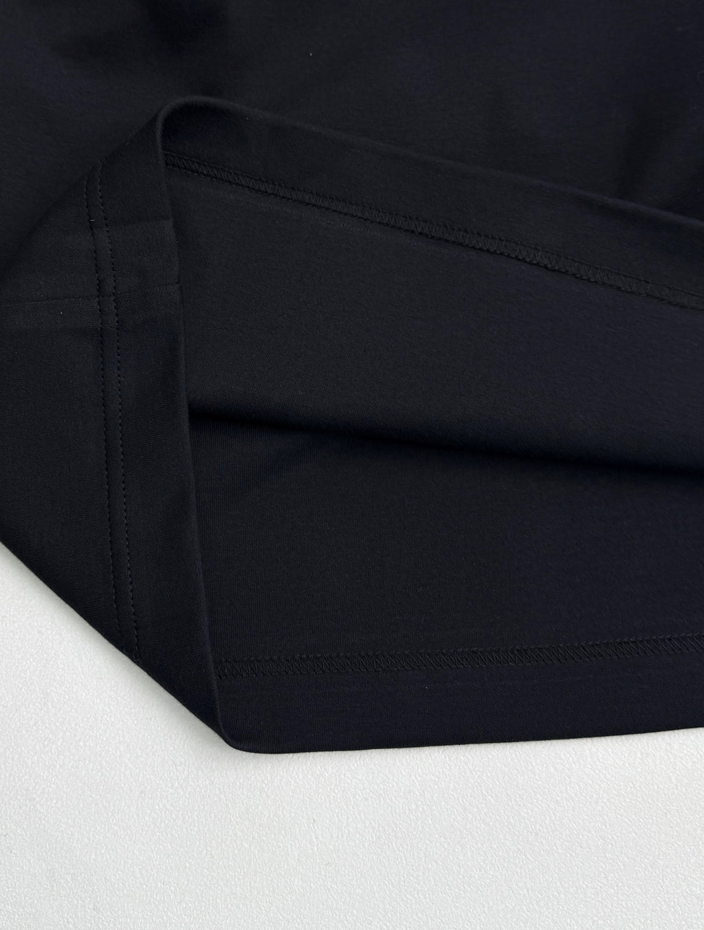 Fendi T-shirt fabric close-up with double-stitched hem in dark navy