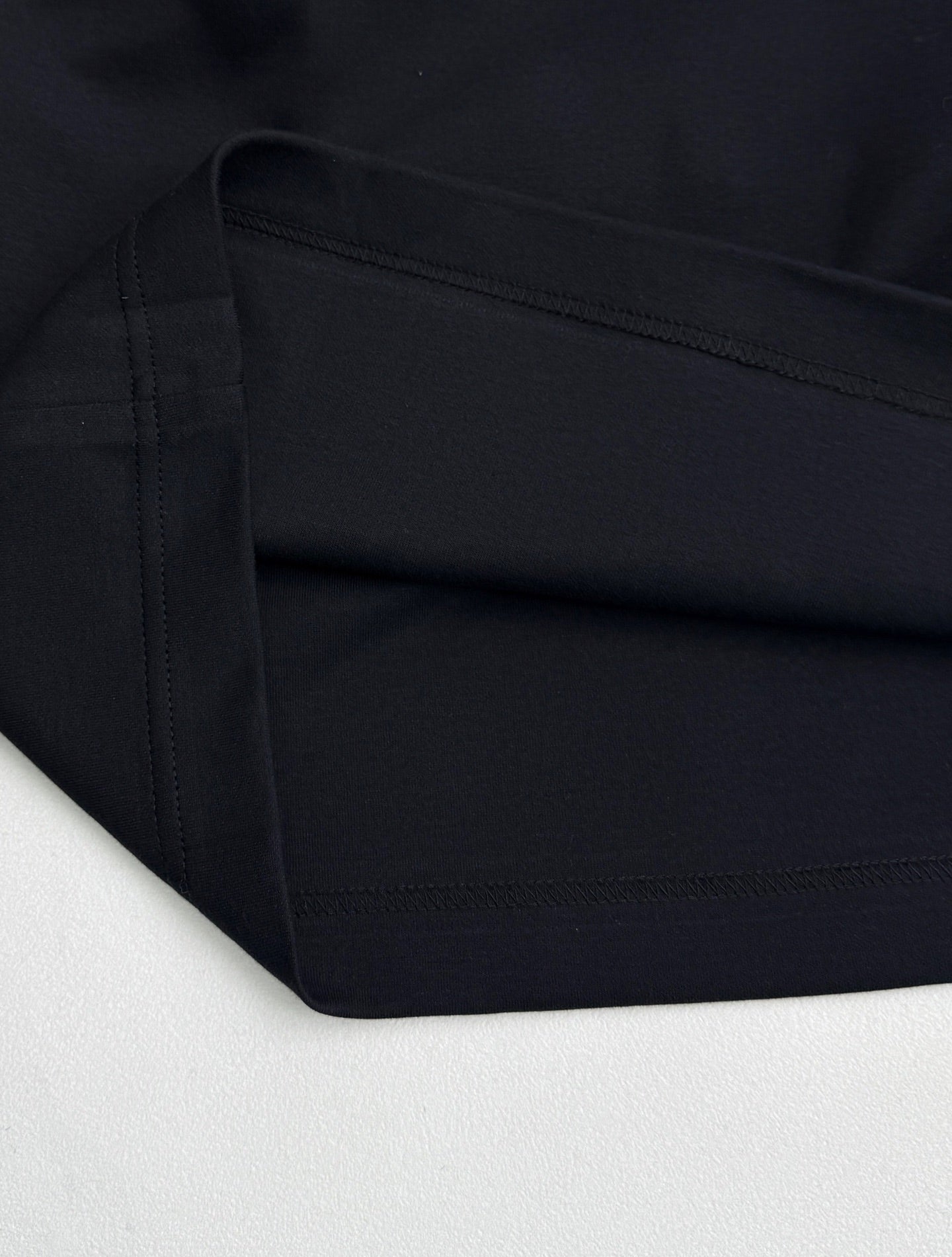 Fendi T-shirt fabric close-up with double-stitched hem in dark navy
