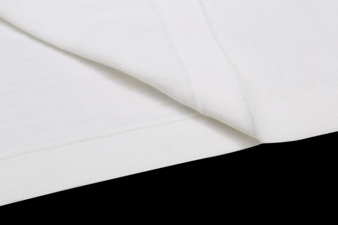 White T-shirt fabric folds and stitching near shoulder