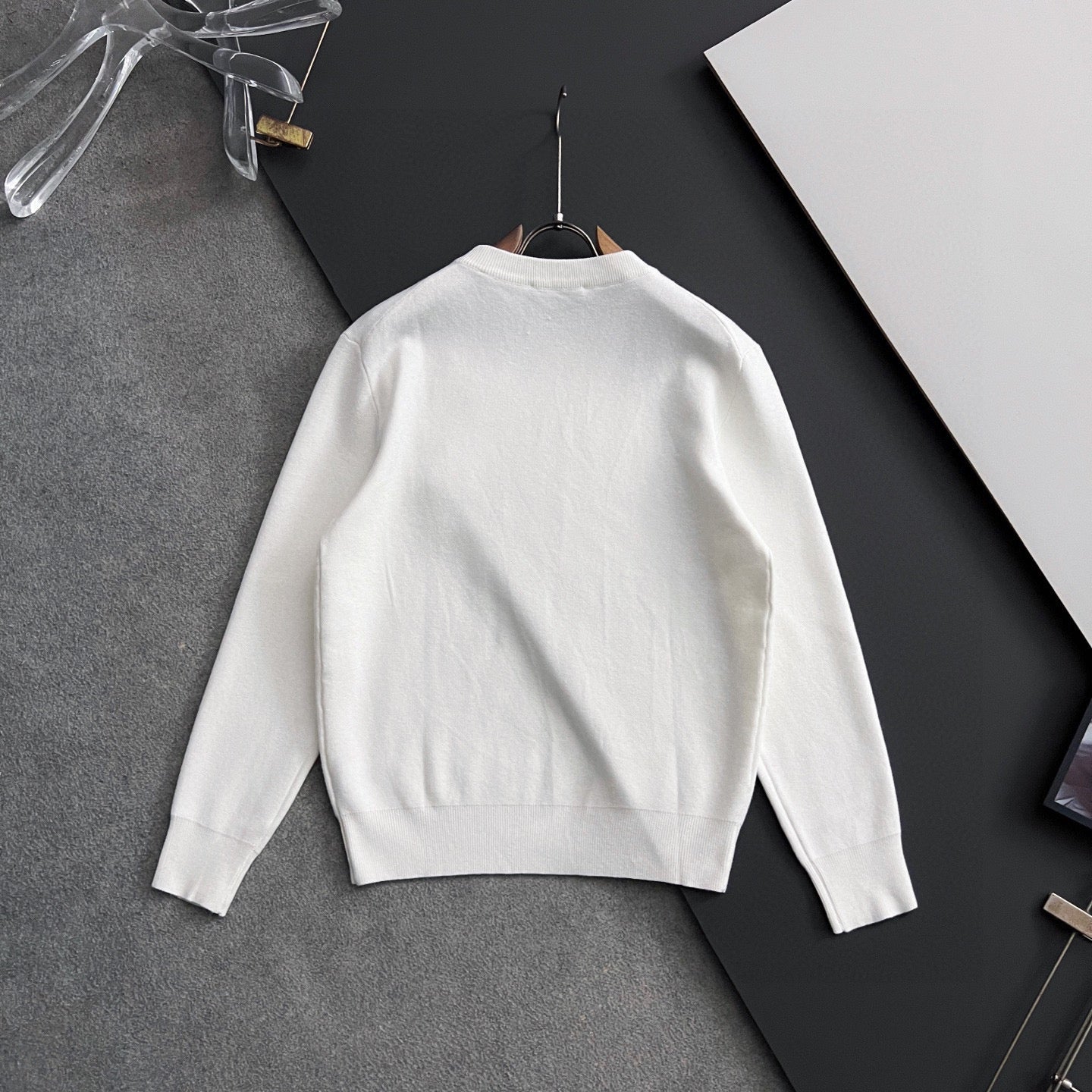White long-sleeve sweatshirt back view with ribbed cuffs and crew neck