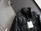 Moncler long puffer jacket, black with stand collar, drawstring, and logo badge