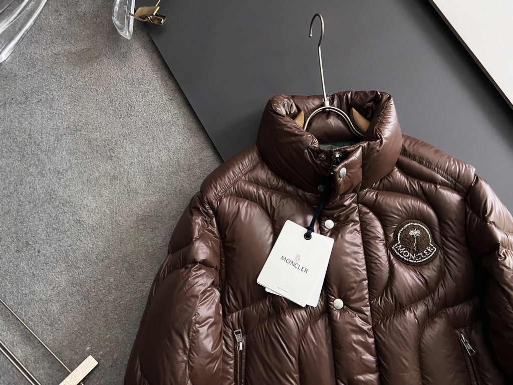 Moncler long puffer jacket in dark brown, front zipper, chest logo patch, hang tag