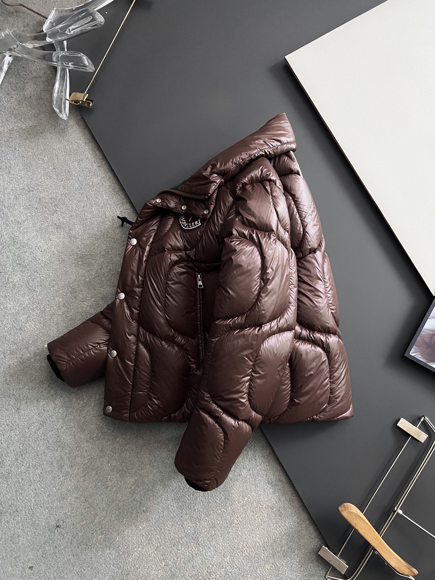 Moncler long puffer jacket in dark brown, quilted panels, hooded back, hanger view