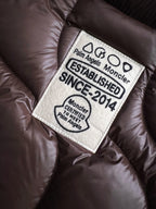 Palm Angels Moncler label reading 'ESTABLISHED 2014' on dark brown quilted fabric