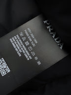 Prada puffer jacket care label with printed size and washing symbols