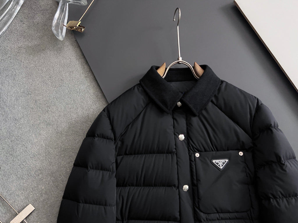 Prada long black puffer jacket front view with stand collar and triangle chest logo