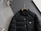 Prada long black puffer jacket front view with stand collar and triangle chest logo