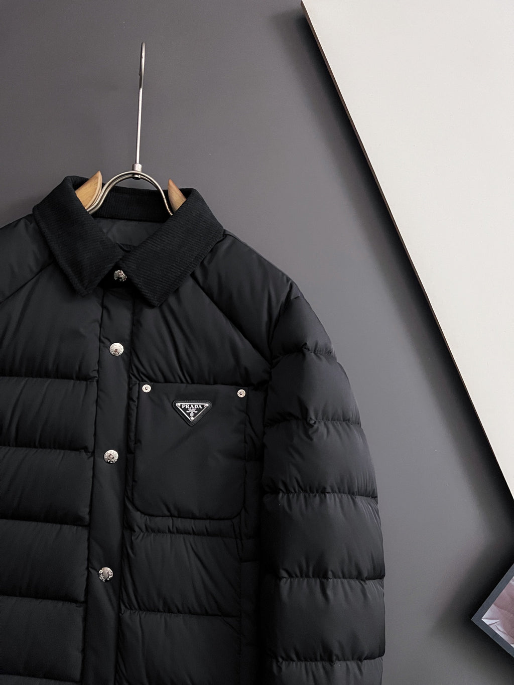 Prada long black puffer jacket with chest pocket and triangle logo badge