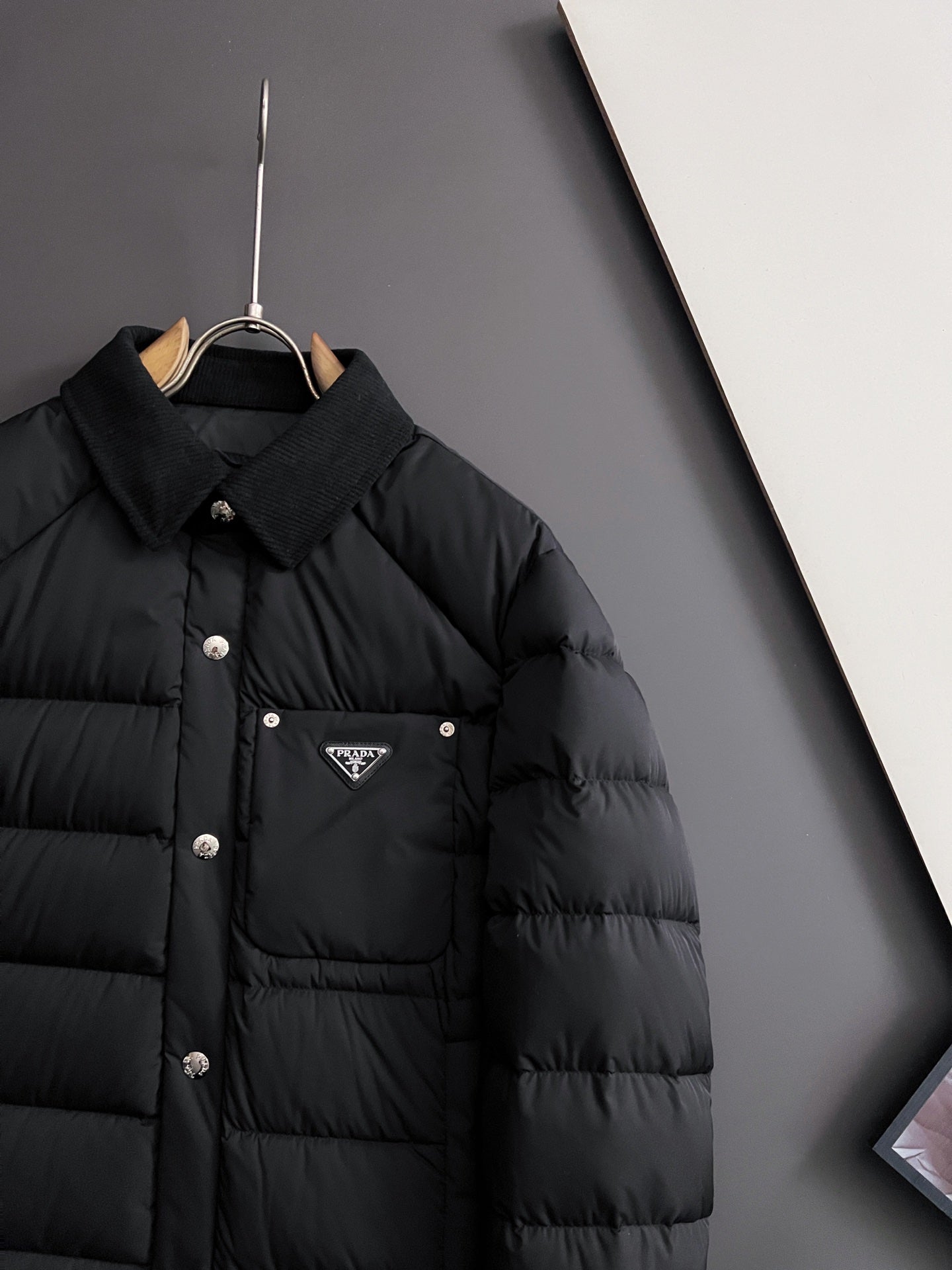 Prada long black puffer jacket with chest pocket and triangle logo badge