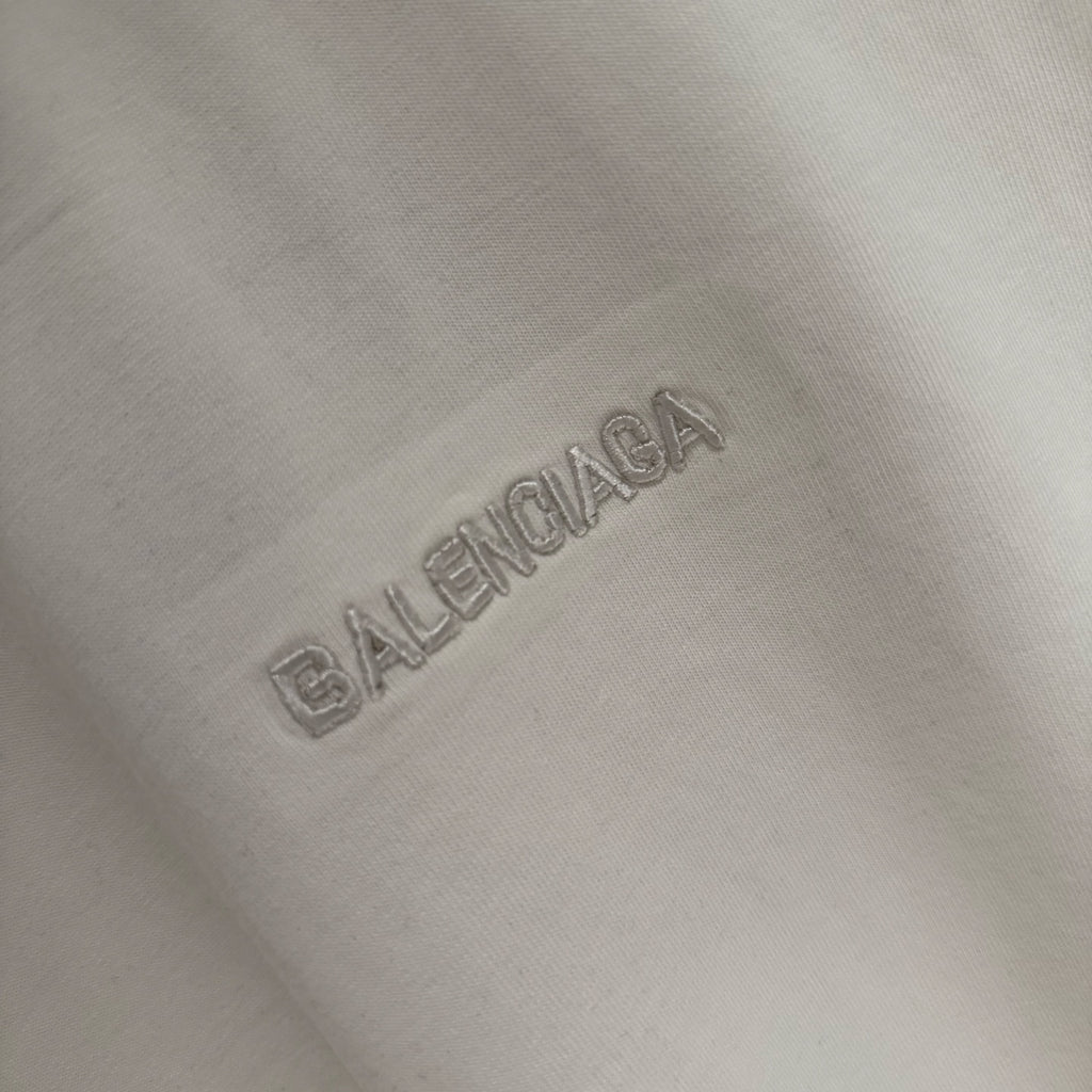 Balenciaga embossed rhinestone logo on white T-shirt fabric
