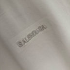 Balenciaga embossed rhinestone logo on white T-shirt fabric