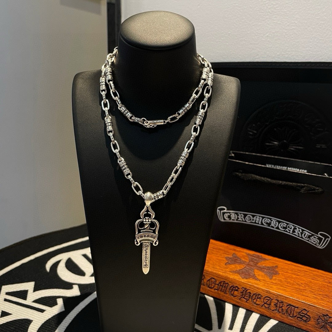 Silver-tone layered chain necklace with dagger charm pendant