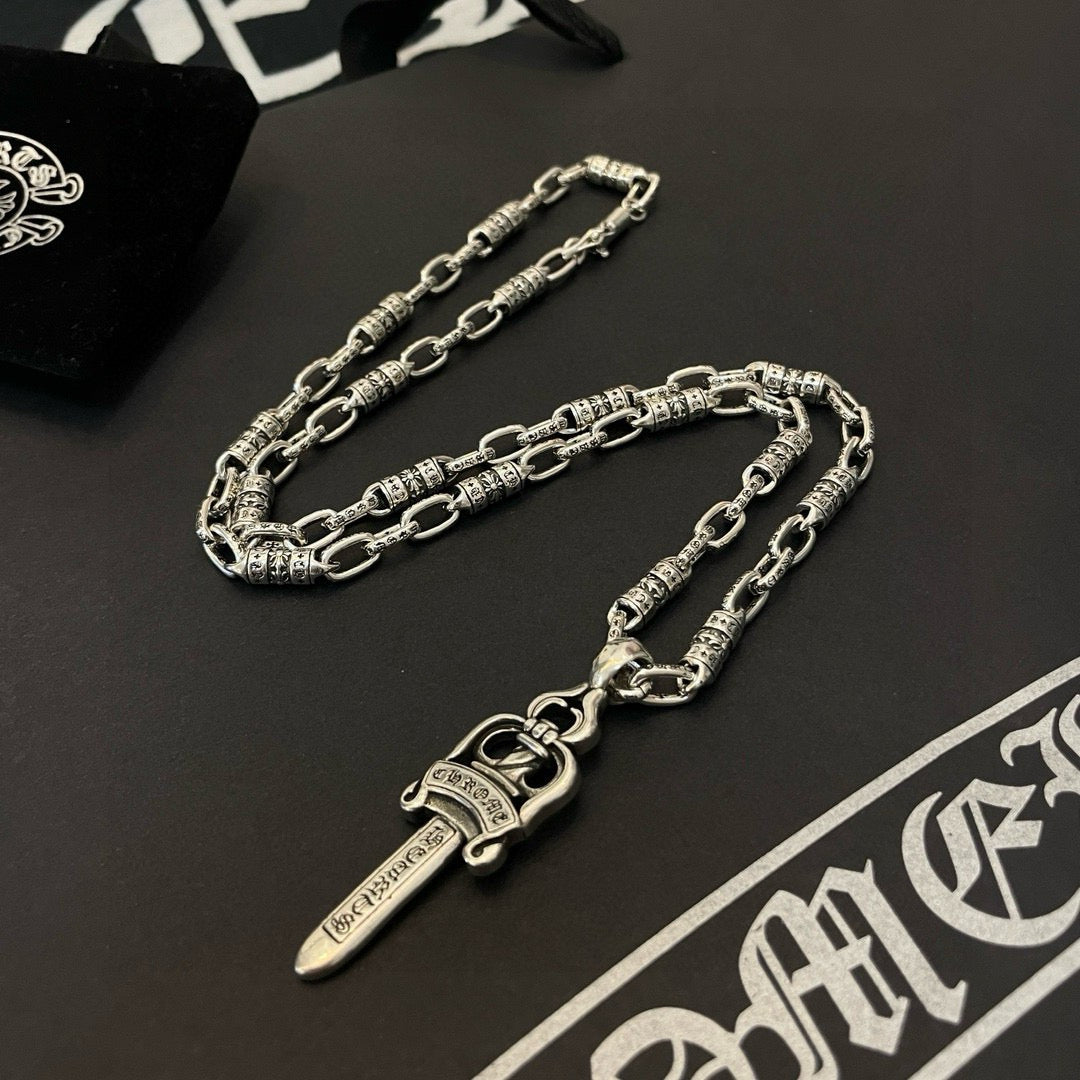 Silver-tone chain necklace with dagger pendant and detailed links