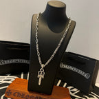 Silver-tone double-chain necklace with dagger pendant on display stand