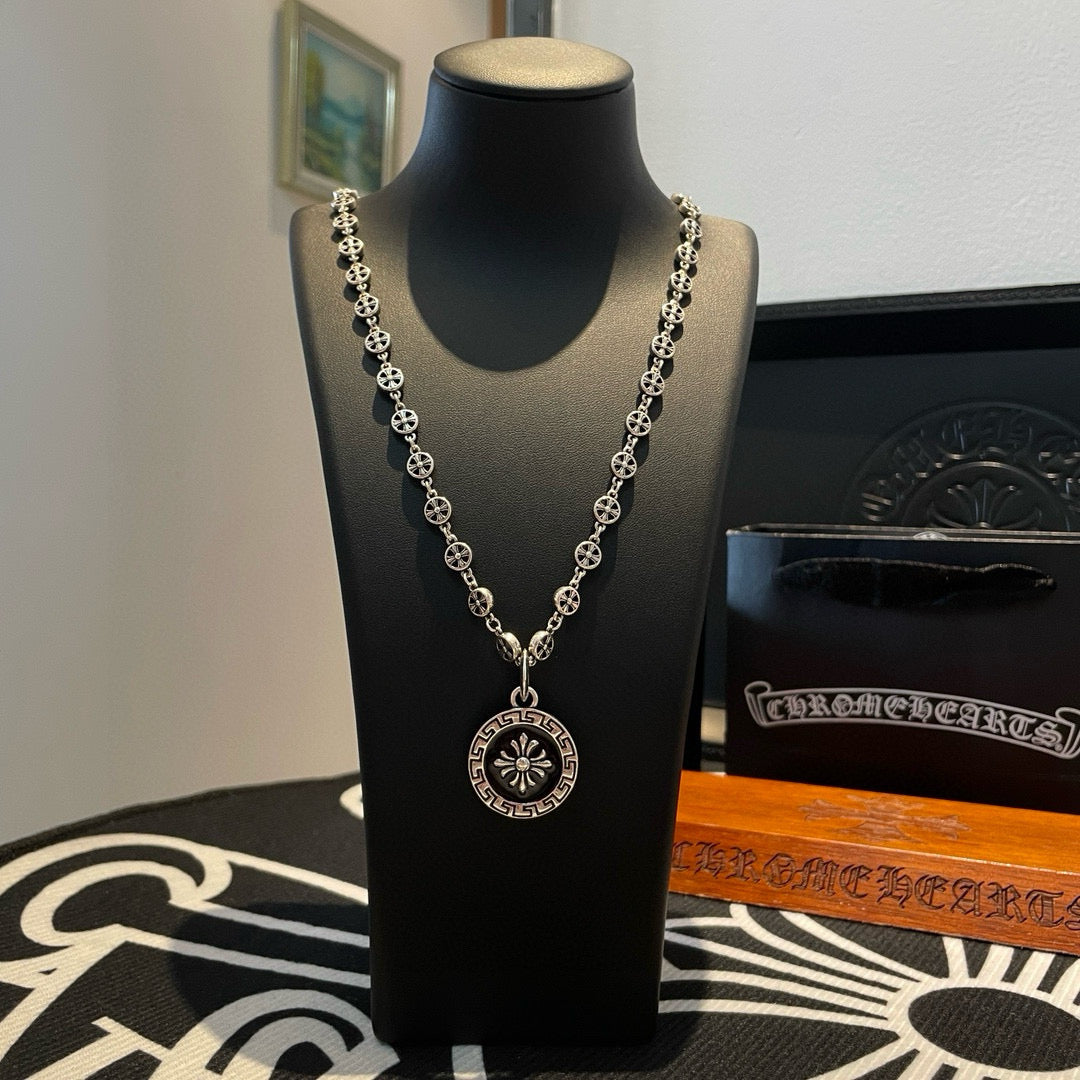 Silver chain necklace with round medallion pendant and small bead links