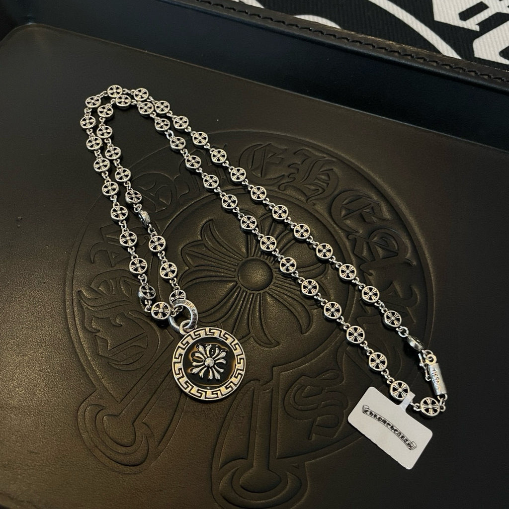 Silver layered chain necklace with round pendant medallion and dangling ID tag