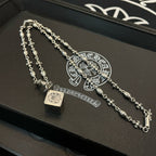 Silver chain necklace set with square pendant and floral motif links on box