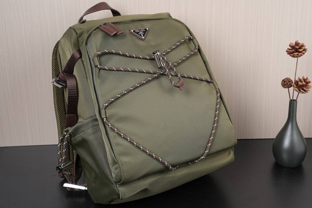 Olive green backpack with front bow-shaped braided design and top handle