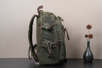 Olive green backpack from side view with adjustable shoulder straps and zipper pocket