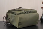 Olive green duffel-style backpack with top handle and braided strap accent
