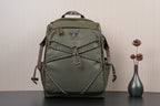Olive green Prada-style backpack with front zipper pocket and braided trim