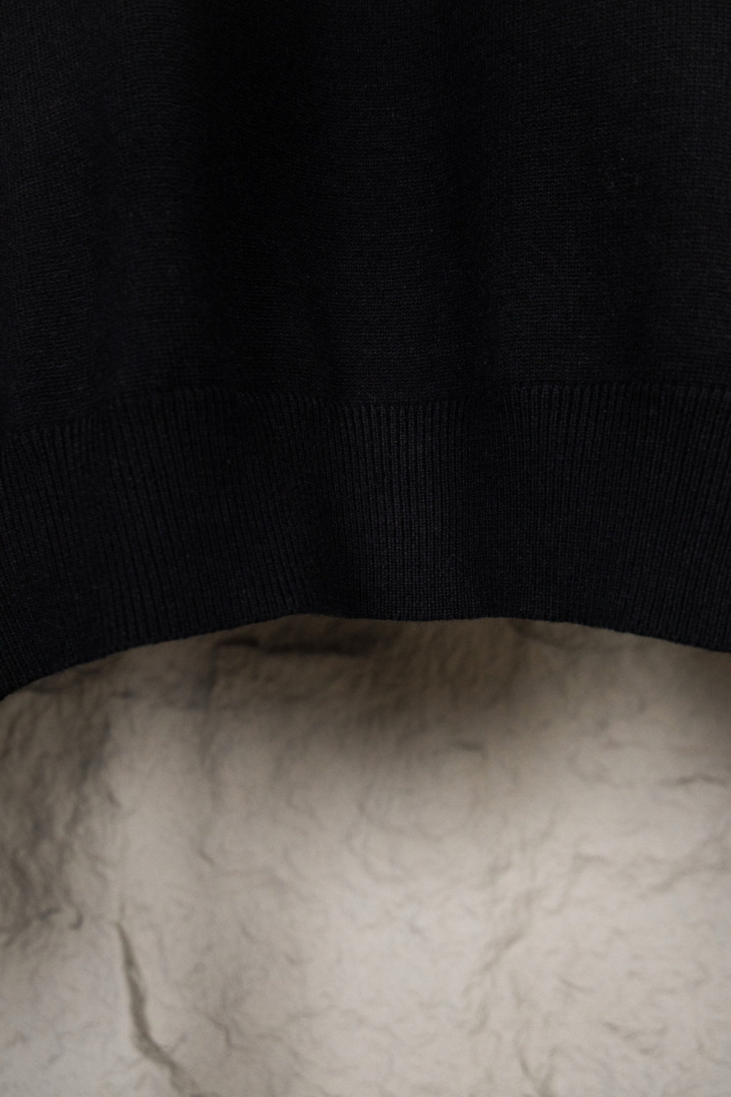Black knit sweater fabric and ribbed hem