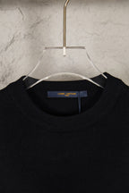 Black knit sweater neckline with Louis Vuitton label