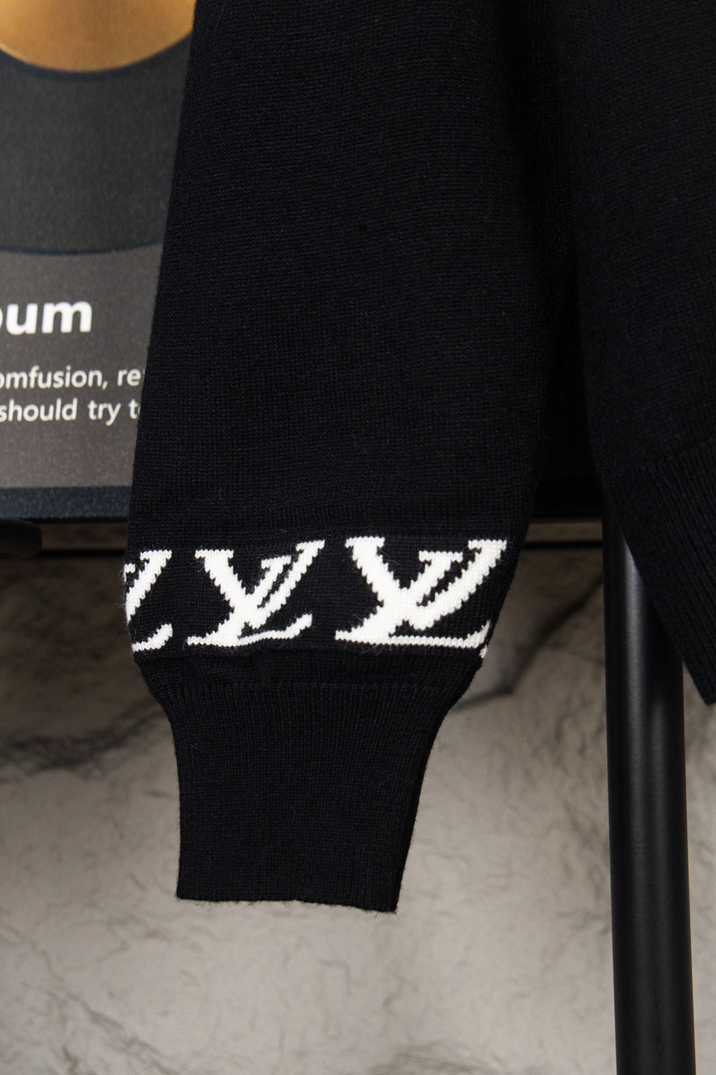 Black knit sweater cuff with white LV monogram stripe
