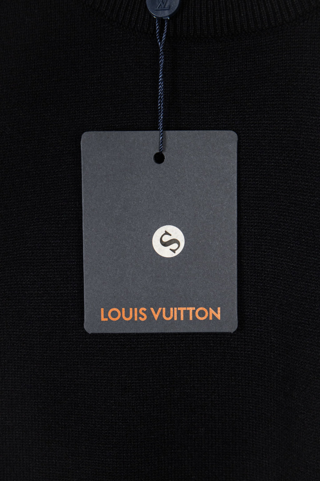 Black knit sweater hang tag with Louis Vuitton logo