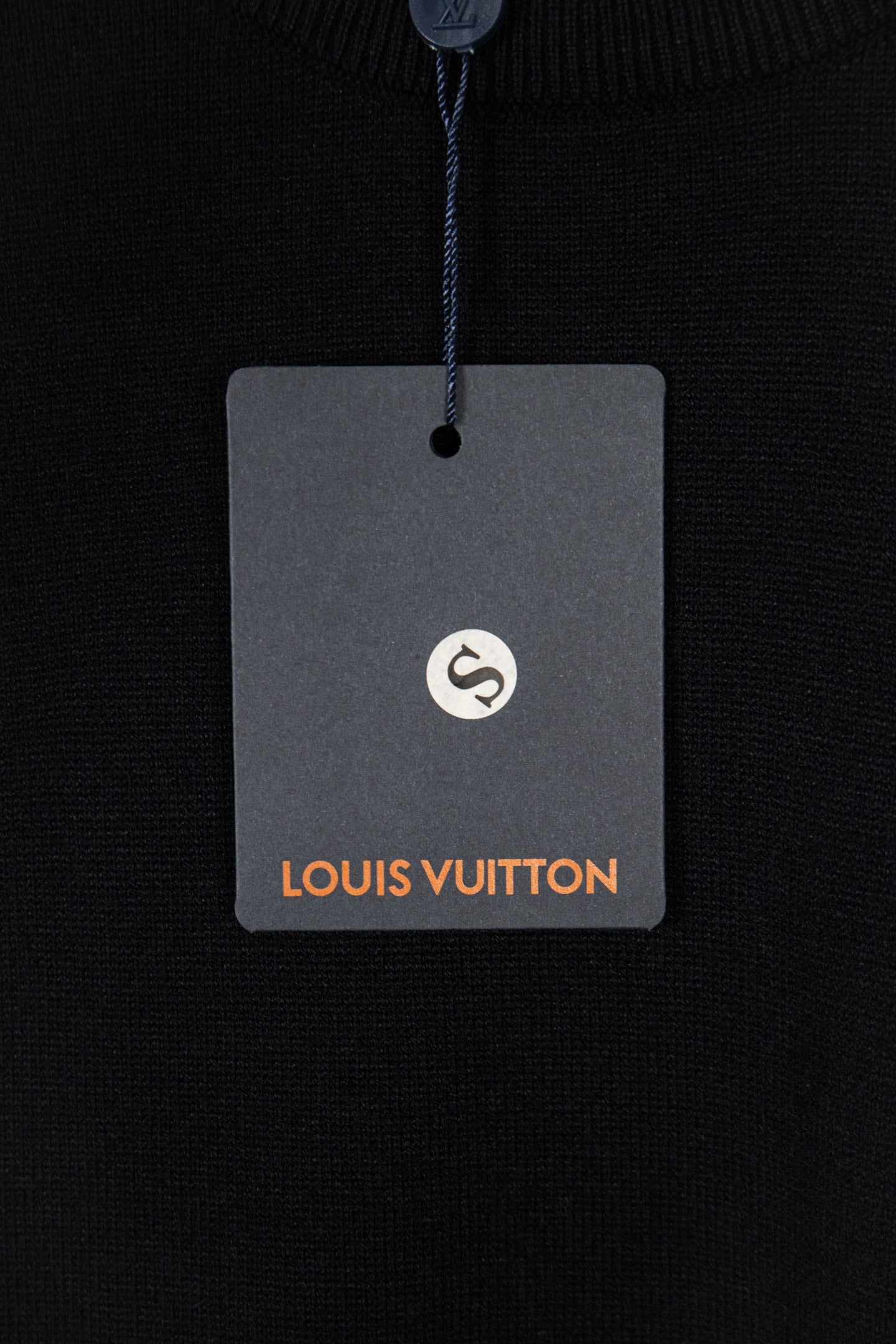 Black knit sweater hang tag with Louis Vuitton logo
