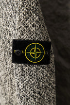 Stone Island logo patch on flecked jacket, black label with yellow emblem